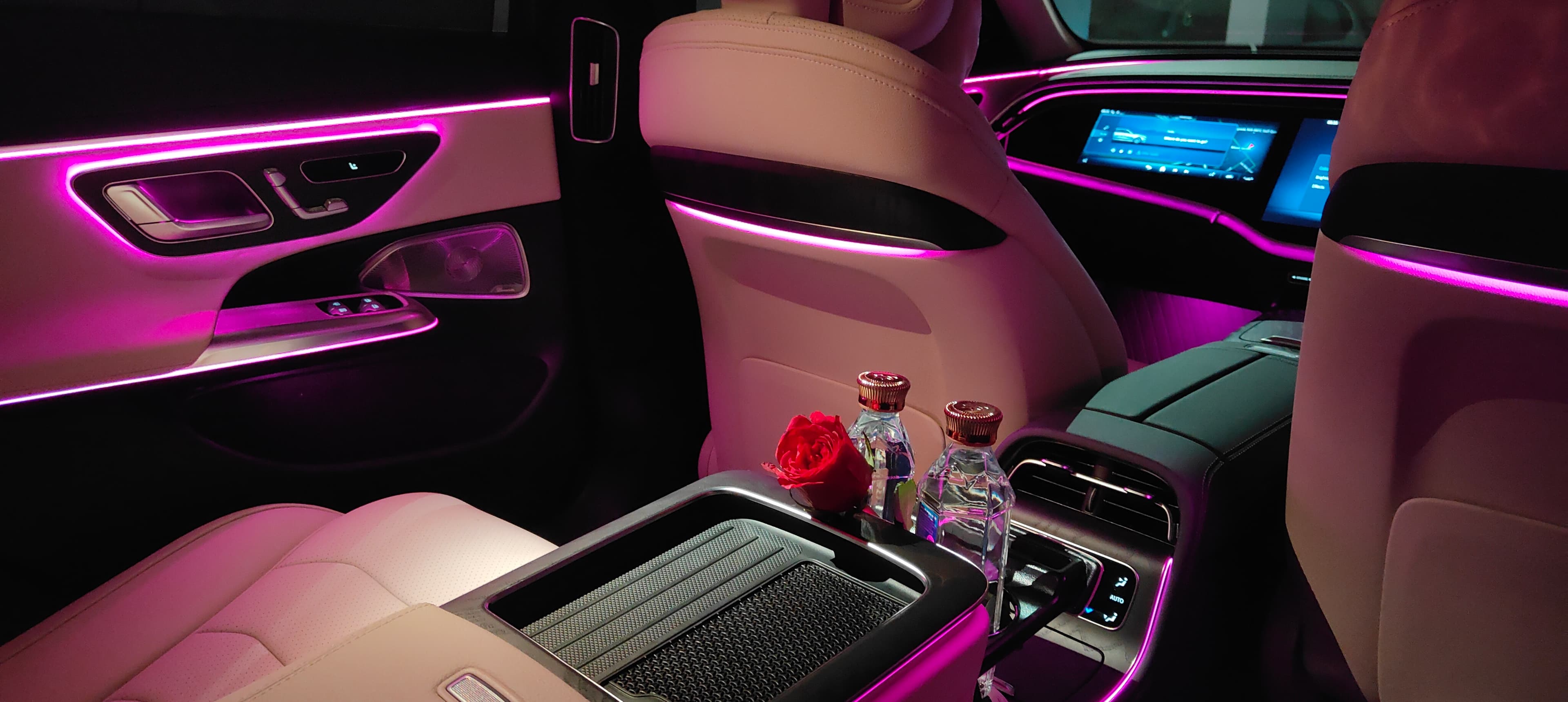 Luxury car rear cabin with ambient lighting and curated amenities — Arista chauffeur service in Bangalore