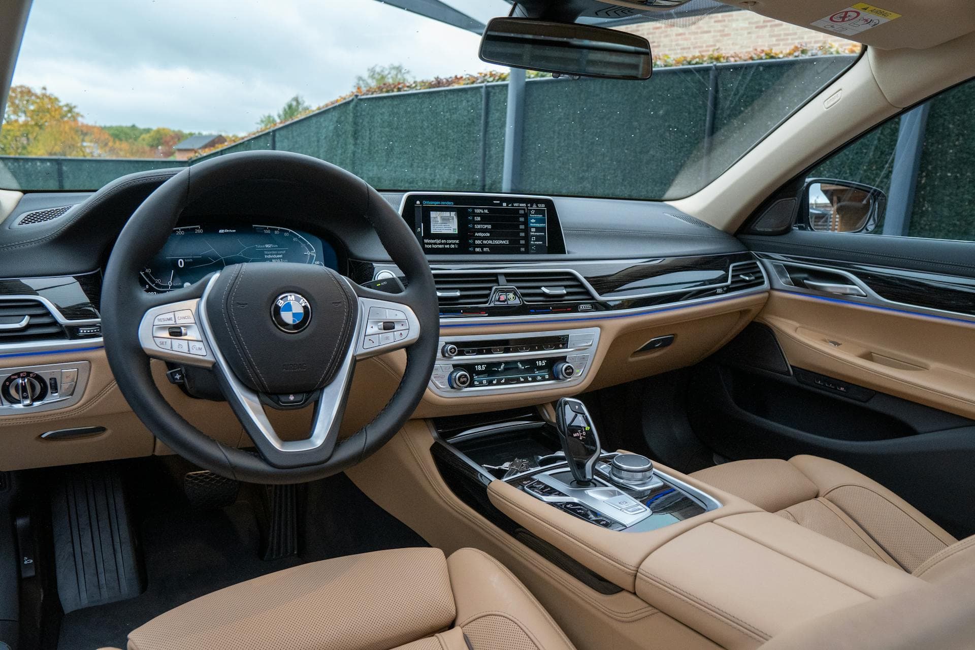 BMW 7 Series luxury interior with cognac leather and iDrive display — premium limousine rental in Bangalore